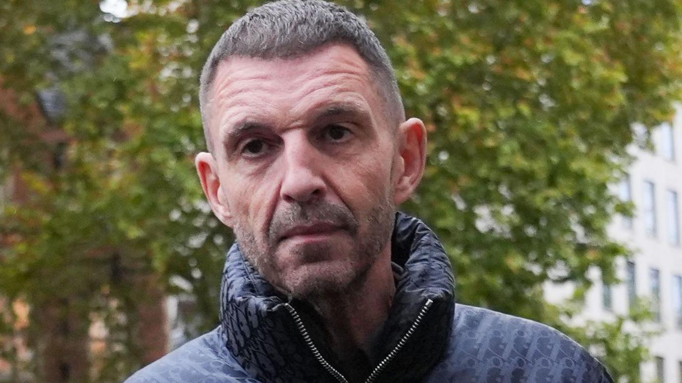 Tim Westwood arriving in court wearing a dark puffer jacket