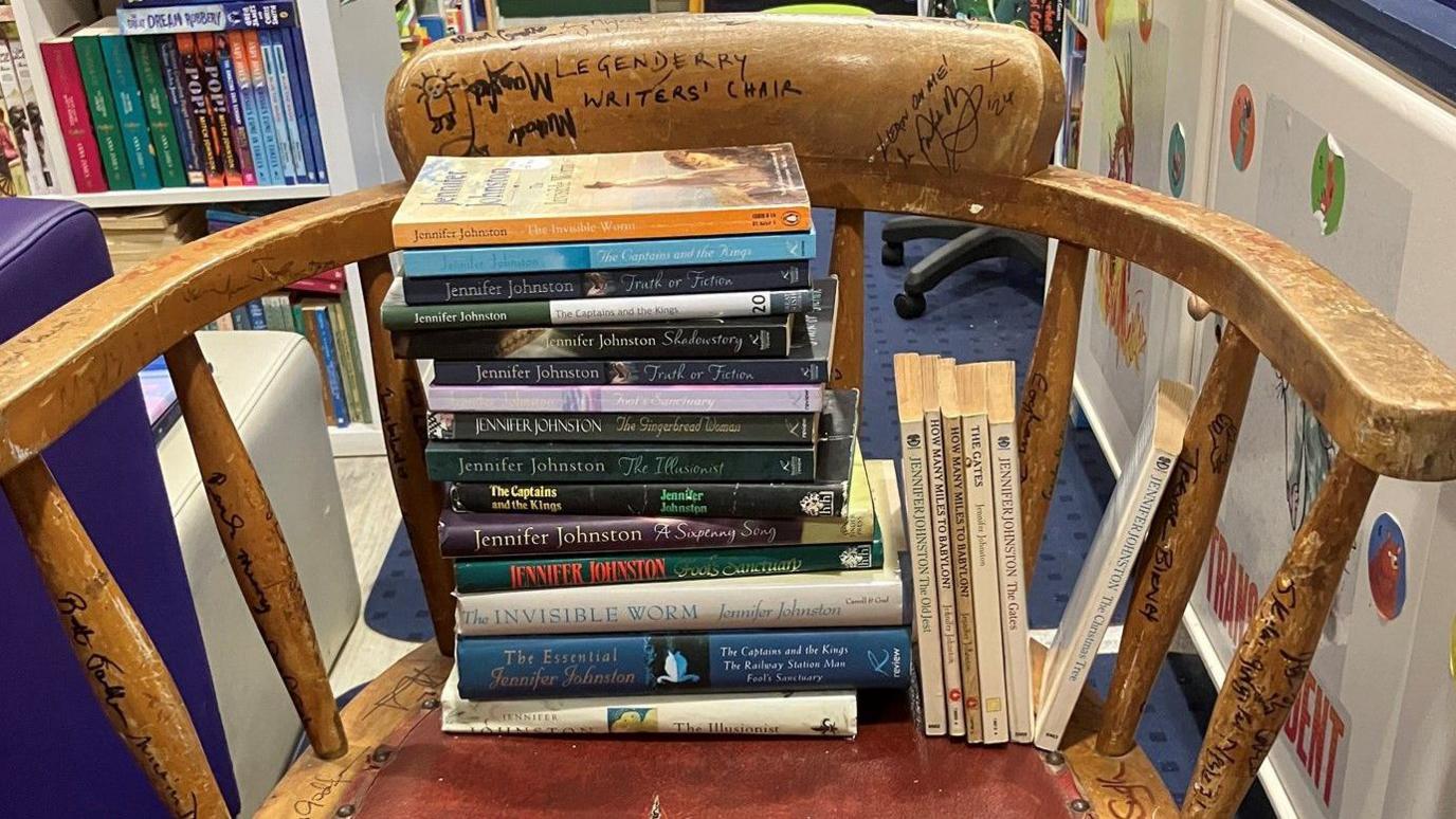 The Legenderry writers' chair in Little Acorns Bookshop with a number of Jennifer Johnston's books set on it