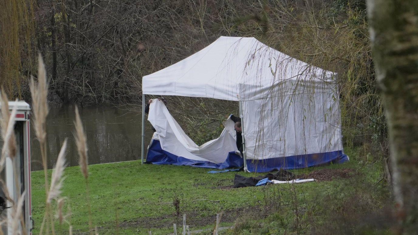 A gazebo being erected by police 