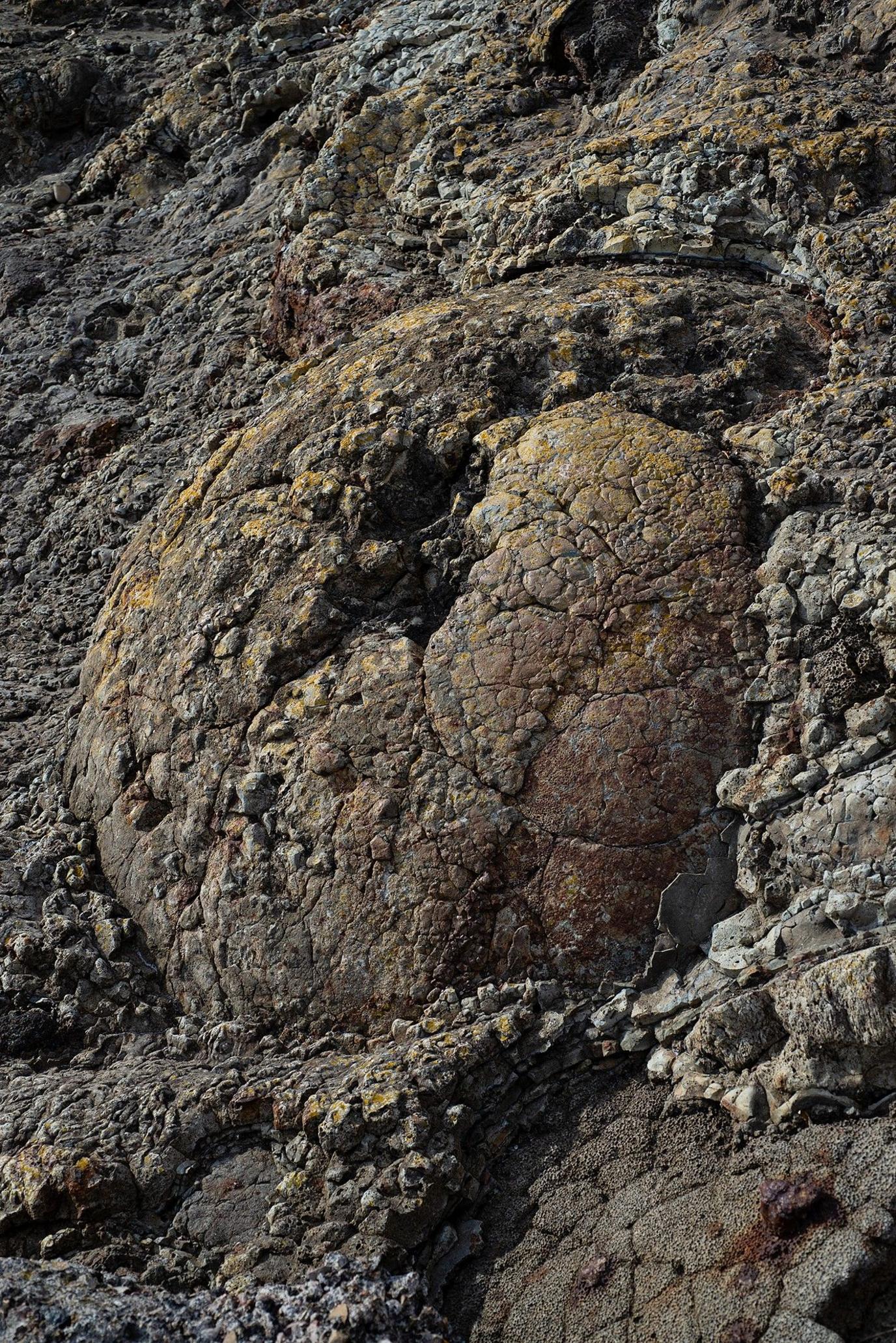 Industrial slag mixed with rock on a beach