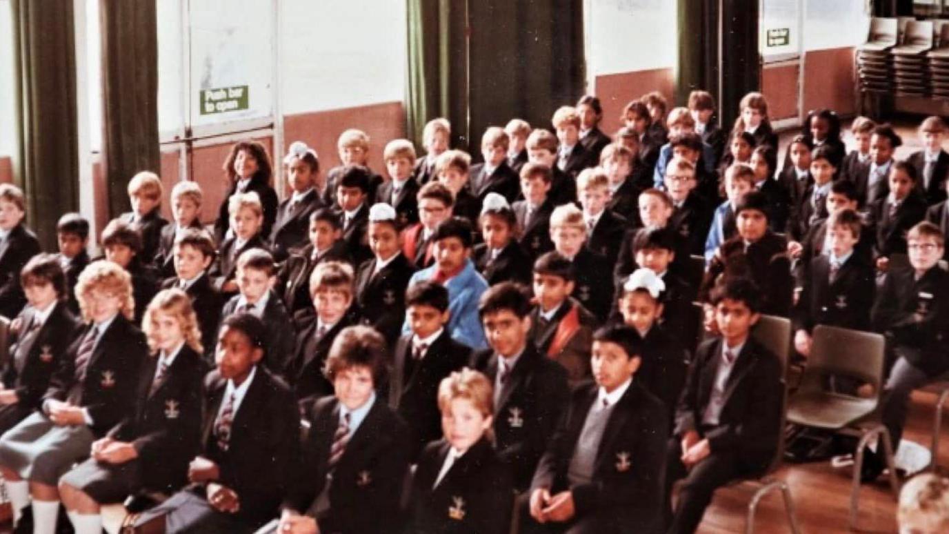 An old school picture of pupils sitting in an assembly hall in Churchfields Comprehensive School in 1983