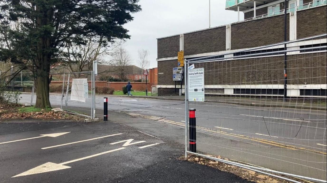 The entrance to the car park which is directly on a main road 