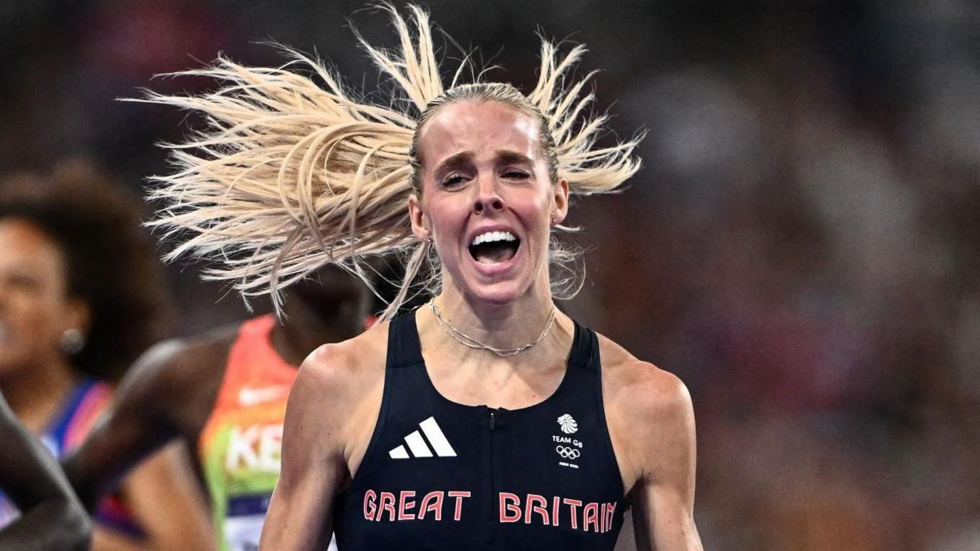 Keely Hodgkinson celebrates as she wins Olympic 800m gold