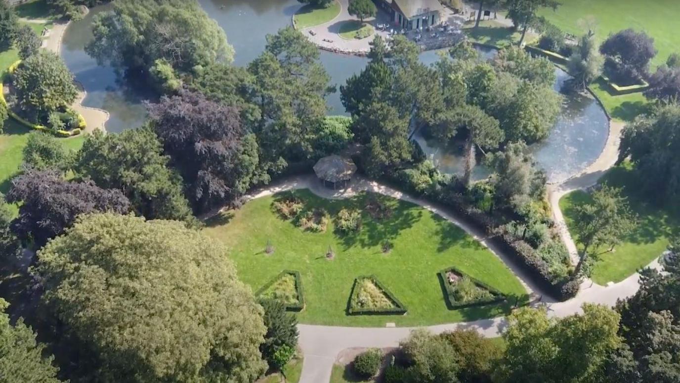 People's Park in Grimsby taken from overhead, showing a pond feature surrounded by trees