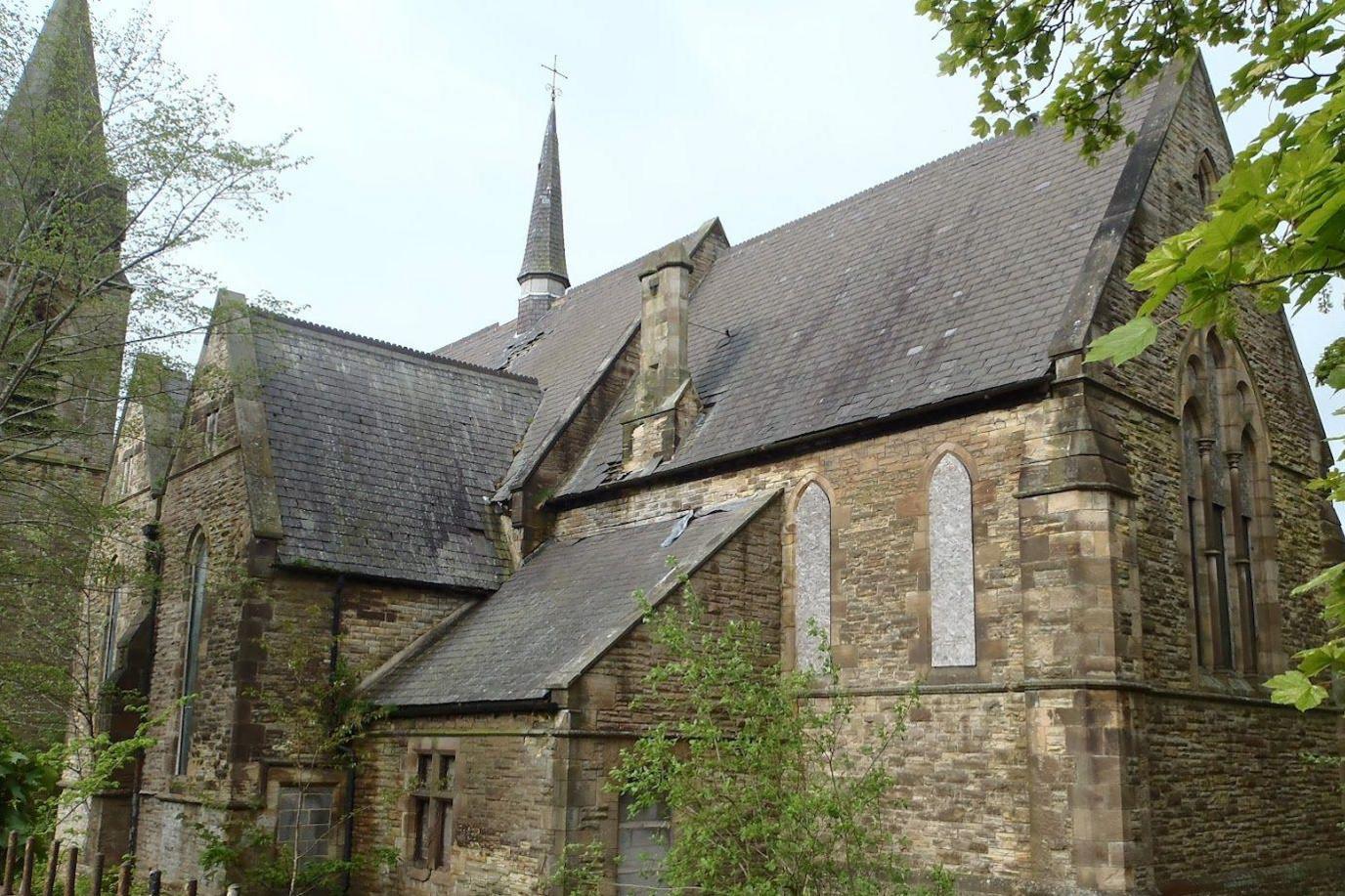 A view of St Aidan's Church in Blackhill, near Consett, County Durham. The church's window's are boarded up, and tiles are visibly missing from the roof. 