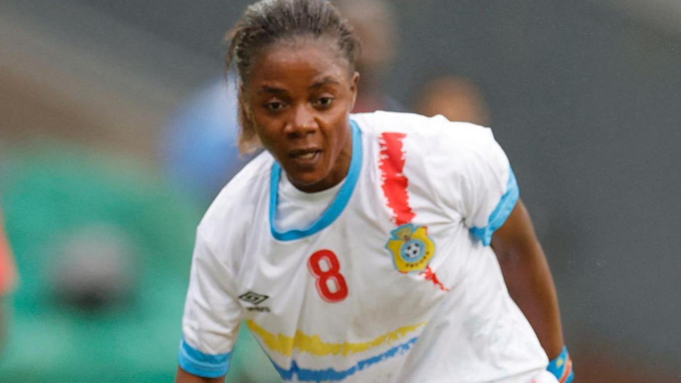 Marlene Yav Kasaj in action for DR Congo in a white away kit with blue trim