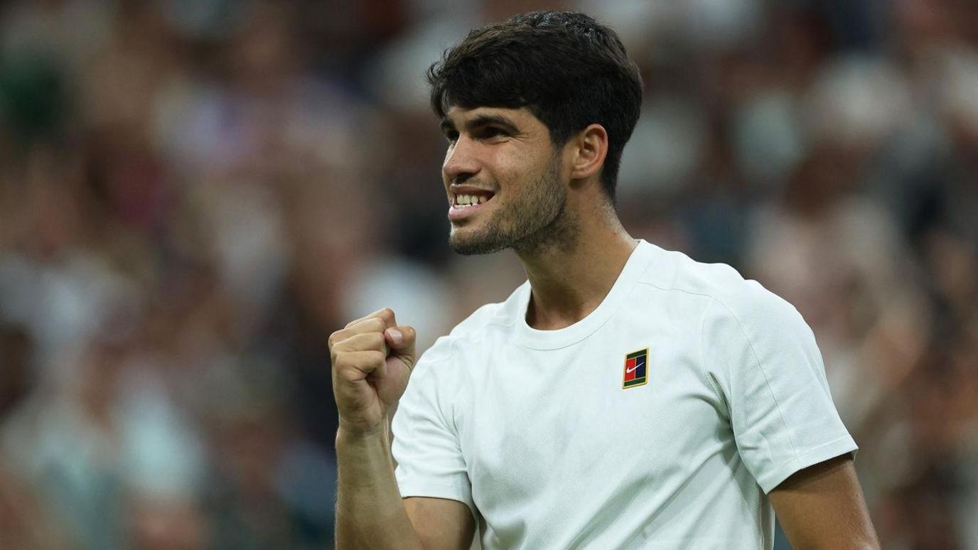 Carlos Alcaraz celebrates winning a point by clenching his fist