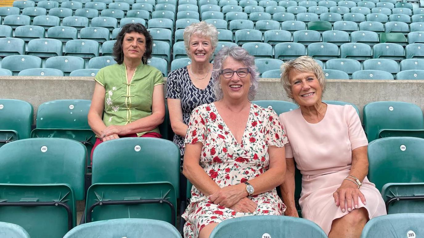 Alice D. Cooper, Sue Forsyth, Deborah Griffin and Sue Dorrington sitting in the seats at Cardiff Arms Park