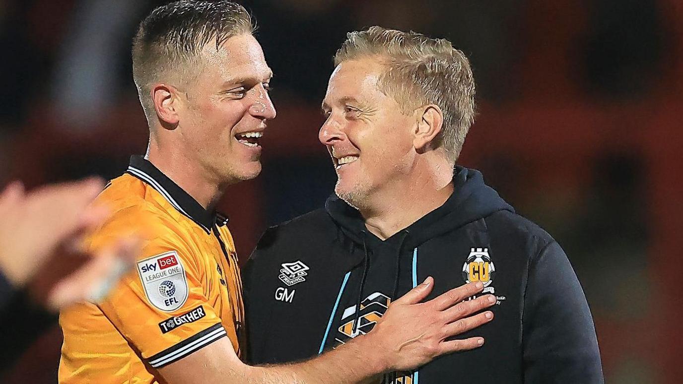 Garry Monk congratulates defender Michael Morrison following their game at Stevenage last month