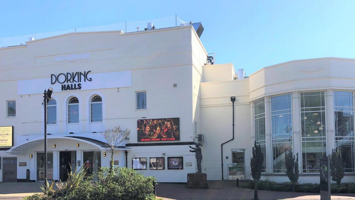 An exterior view of the venue Dorking Halls on a sunny day.