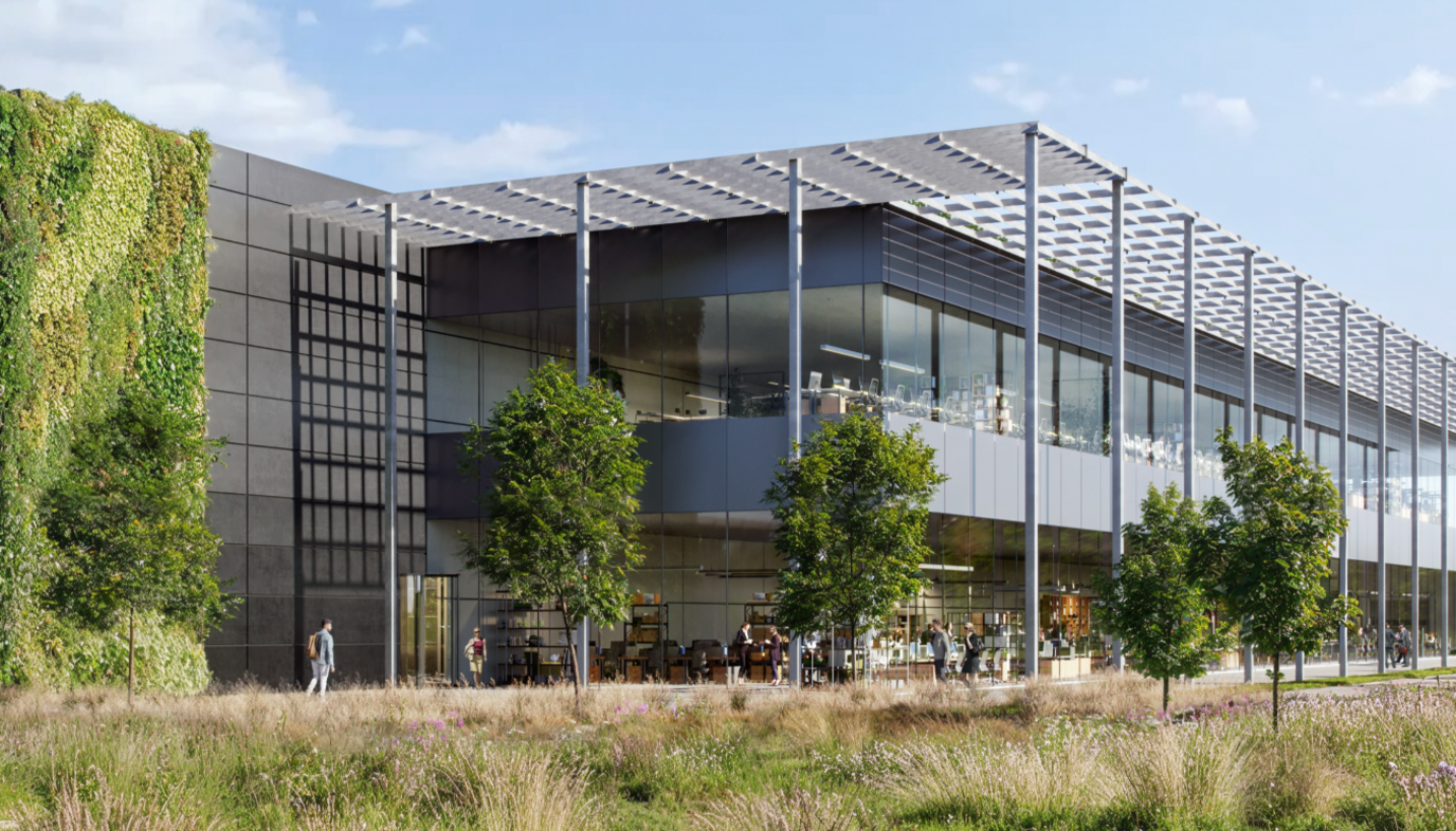 A silver glass building with 4 small trees infront of it