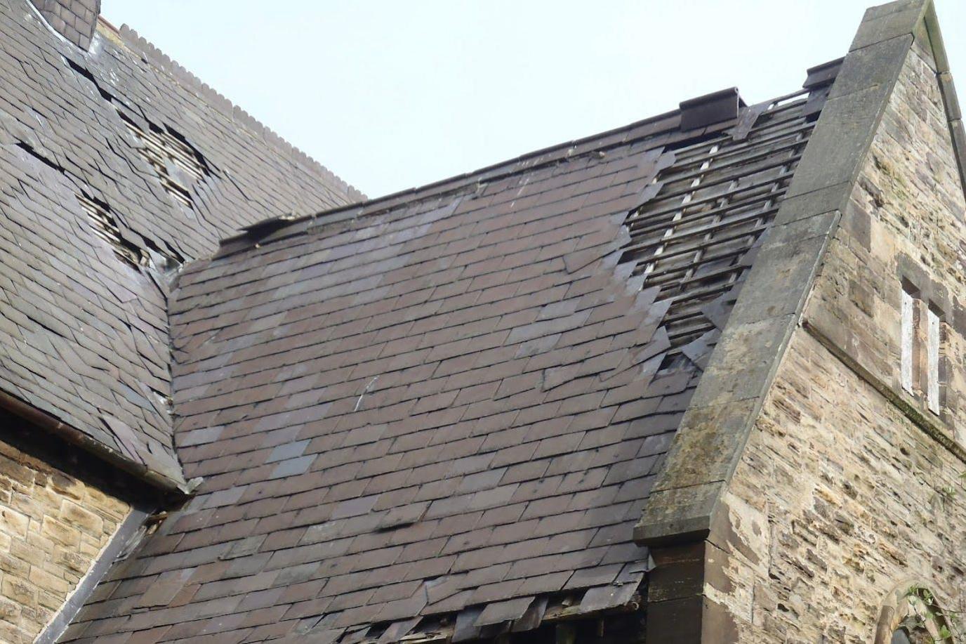 Tiles visibly missing from the church's roof