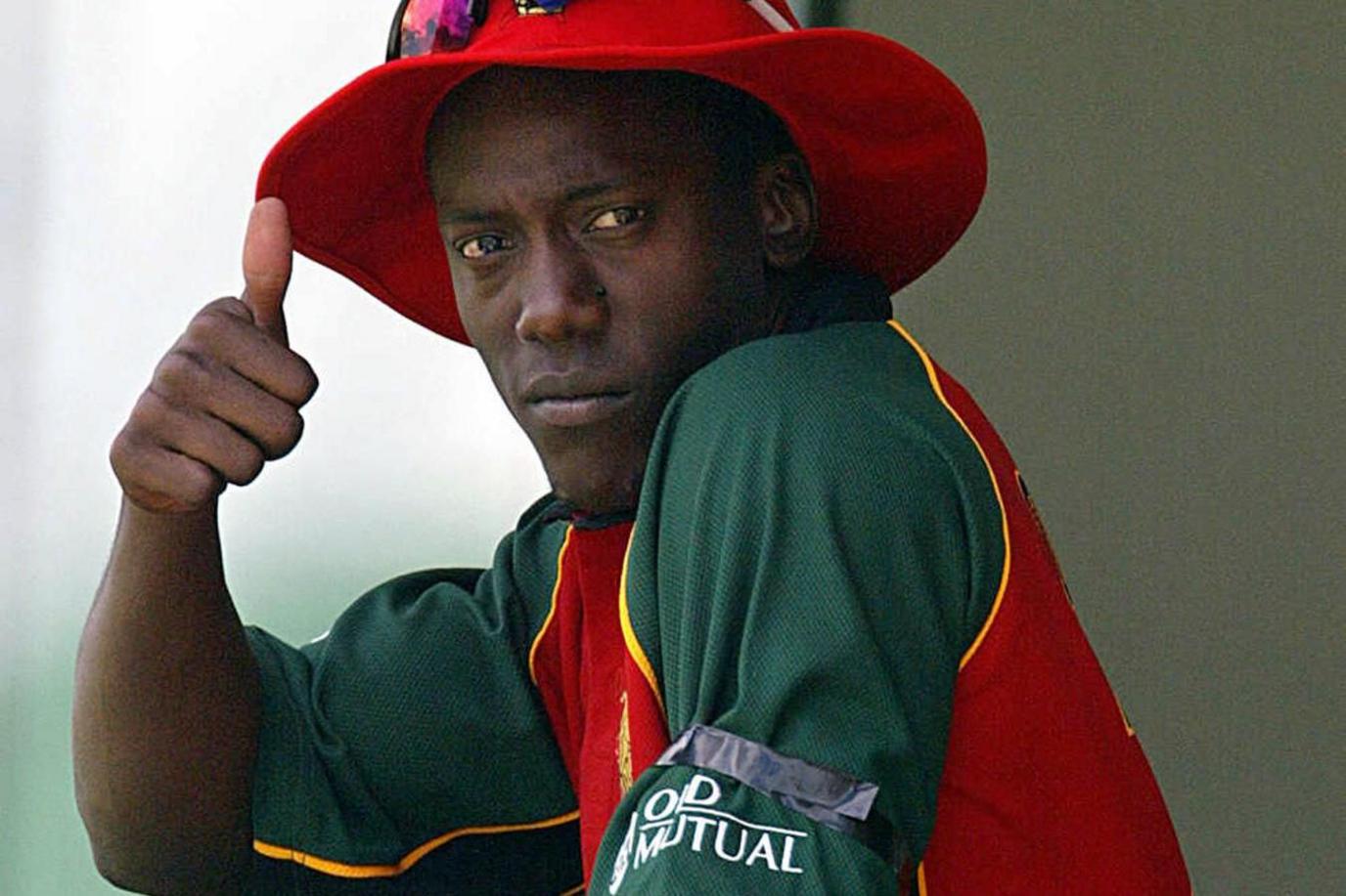 Zimbabwe bowler Henry Olonga gives up a thumbs up, wearing a black armband at the 2003 Cricket World Cup to protest against the Robert Mugabe regime
