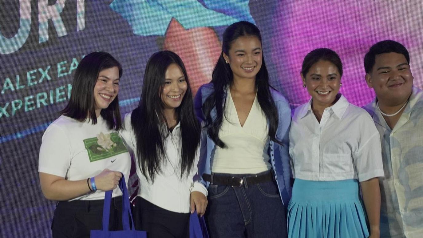 Tennis star Alex Eala poses with fans at a meet and greet in Manila, Philippines