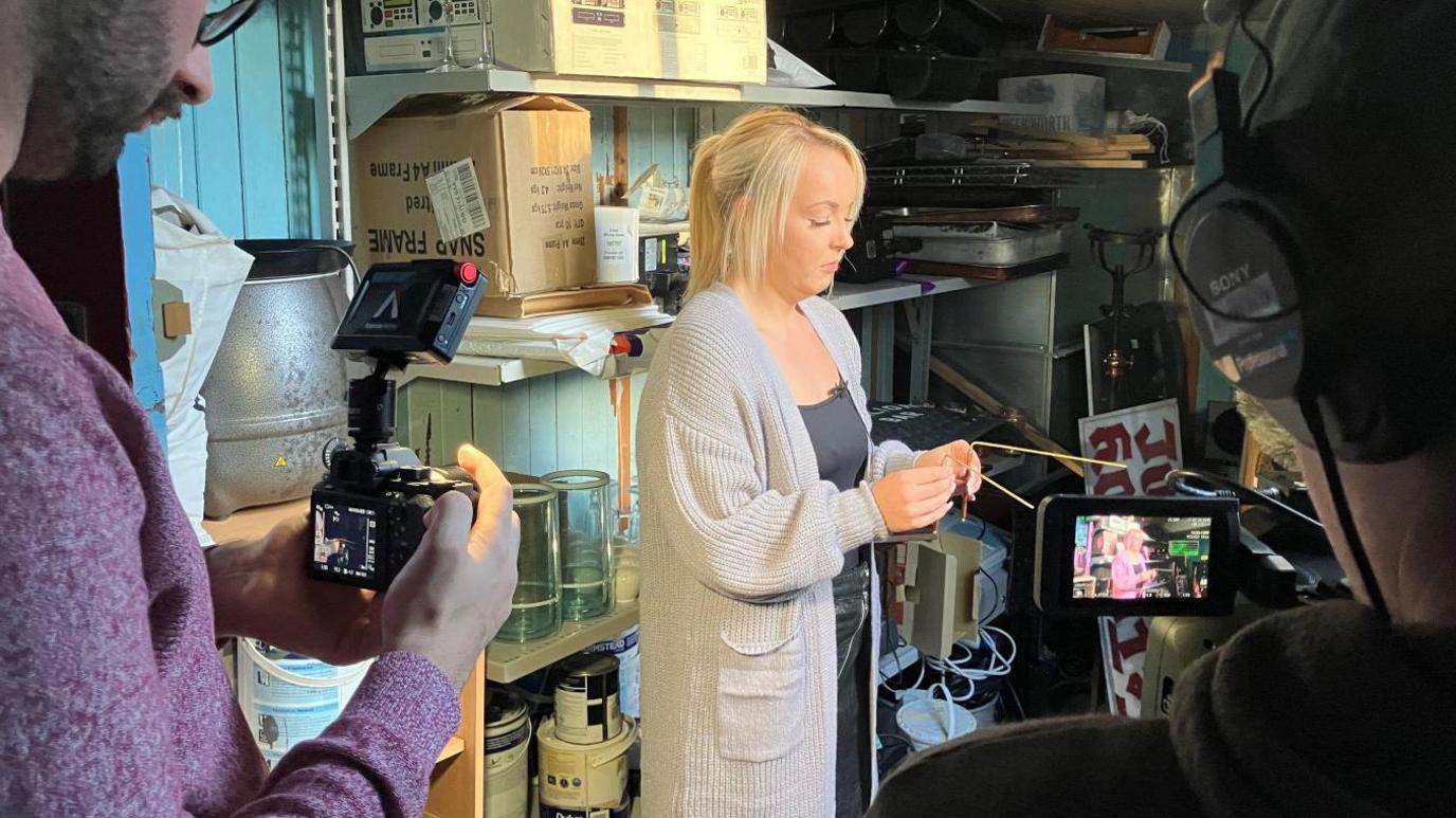 The Social team film Grace using dowsing rods in the attic