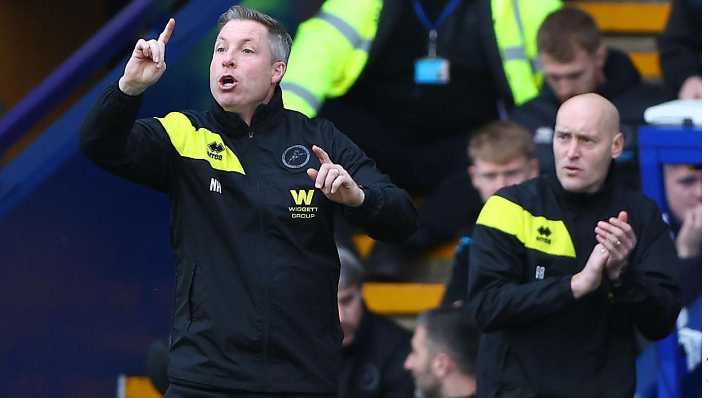 Millwall manager Neil Harris delivers instructions to his players