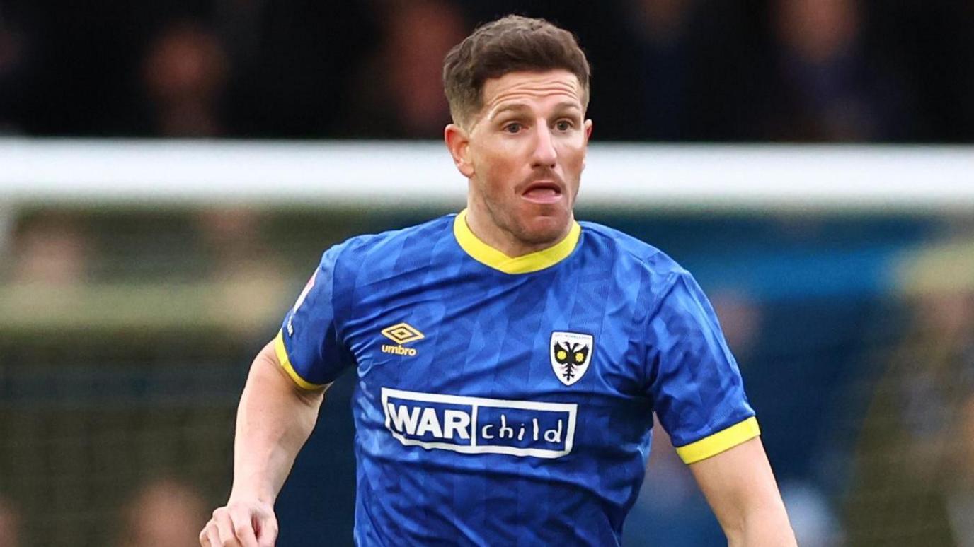 Sam Hutchinson playing for AFC Wimbledon