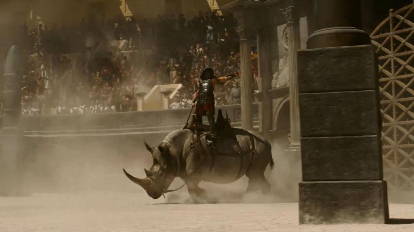 A rhino is ridden into action in the arena