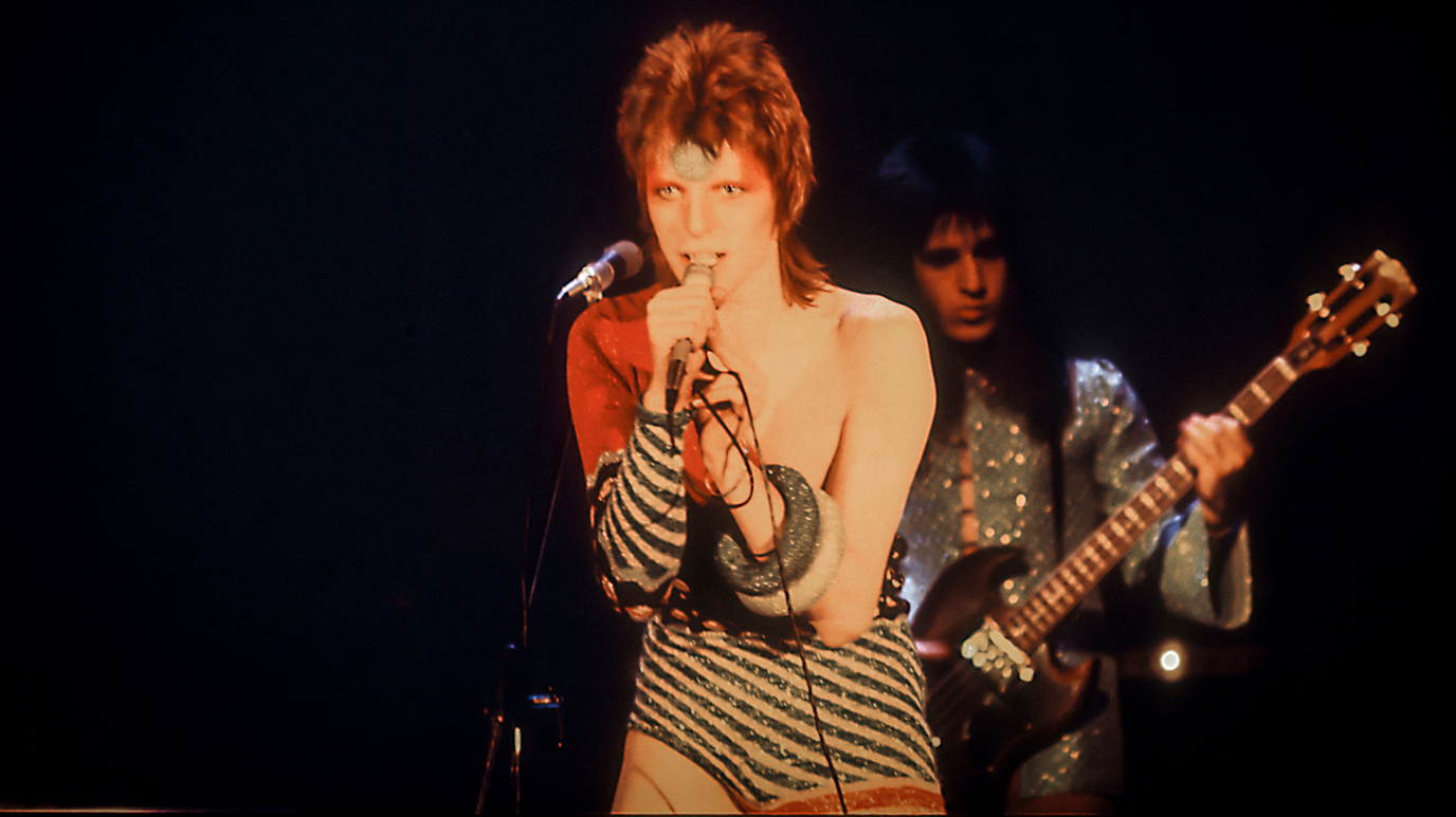 David Bowie wearing a striped sequin leotard while performing as Ziggy Stardust in 1972