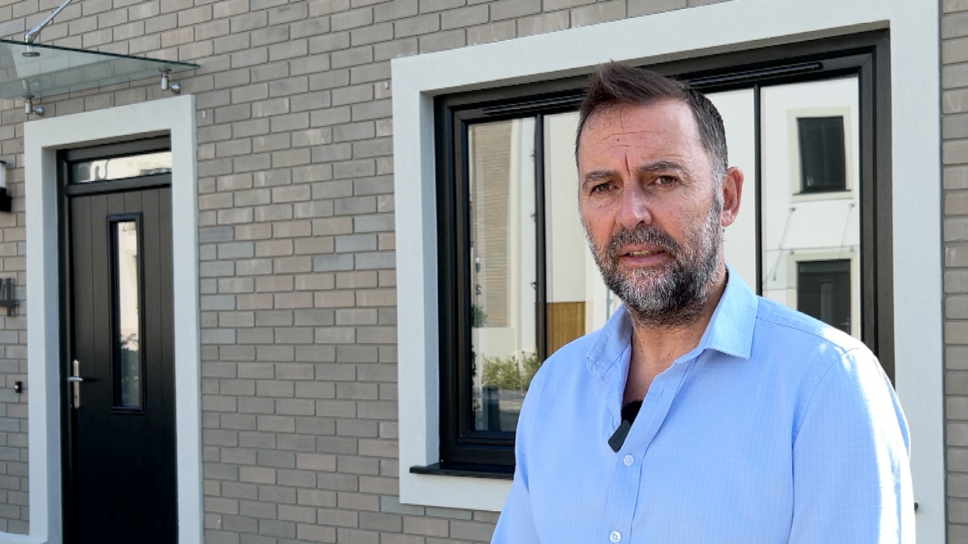 Estate agent Andre Austin outside a property in Guernsey