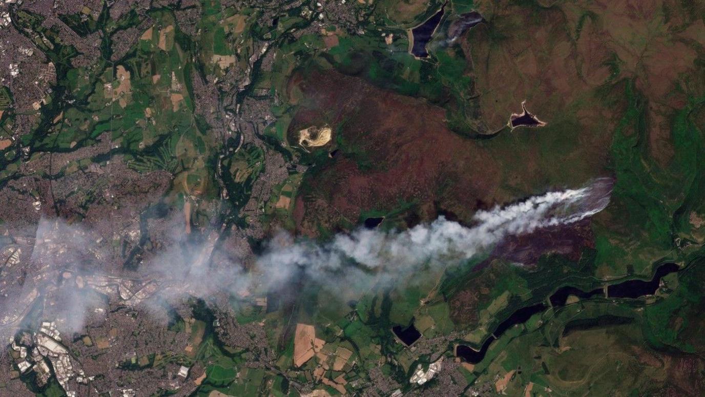 Satellite image showing a smoke plume drifting west