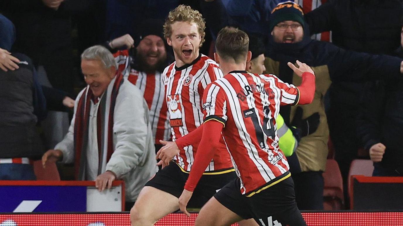 Tom Davies celebrates