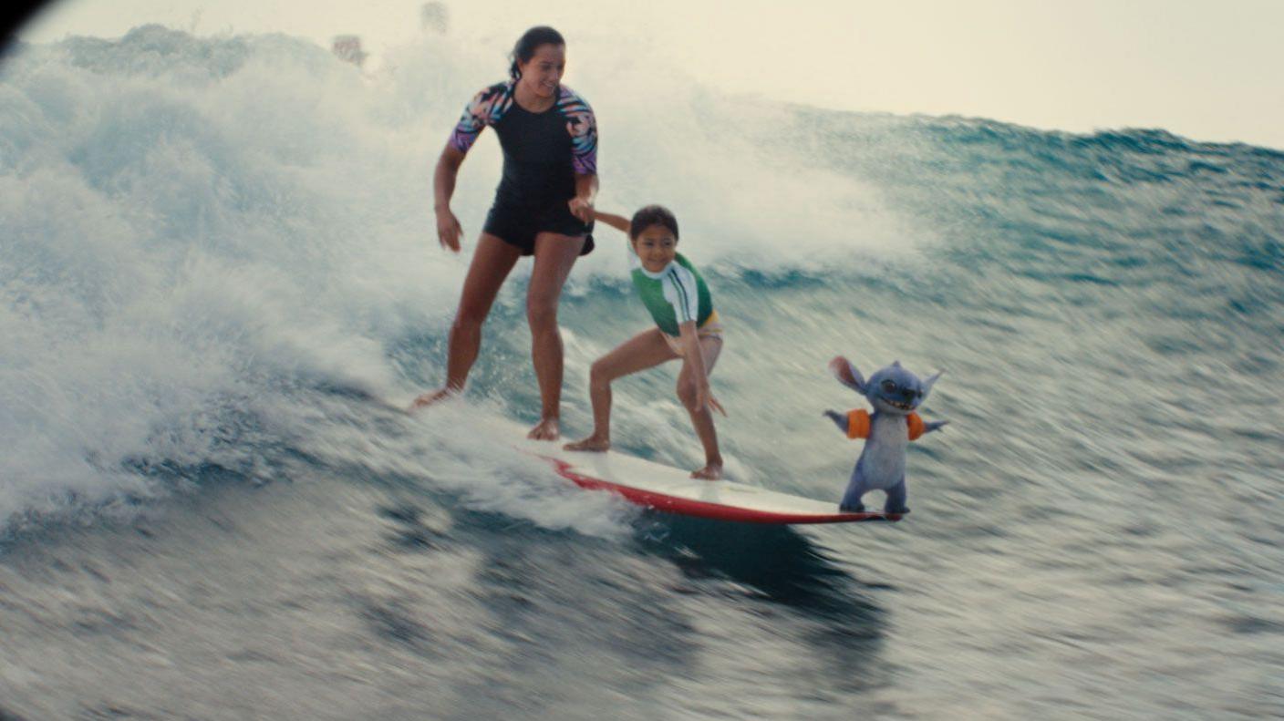 Lilo, Nani and Stitch surfing together.