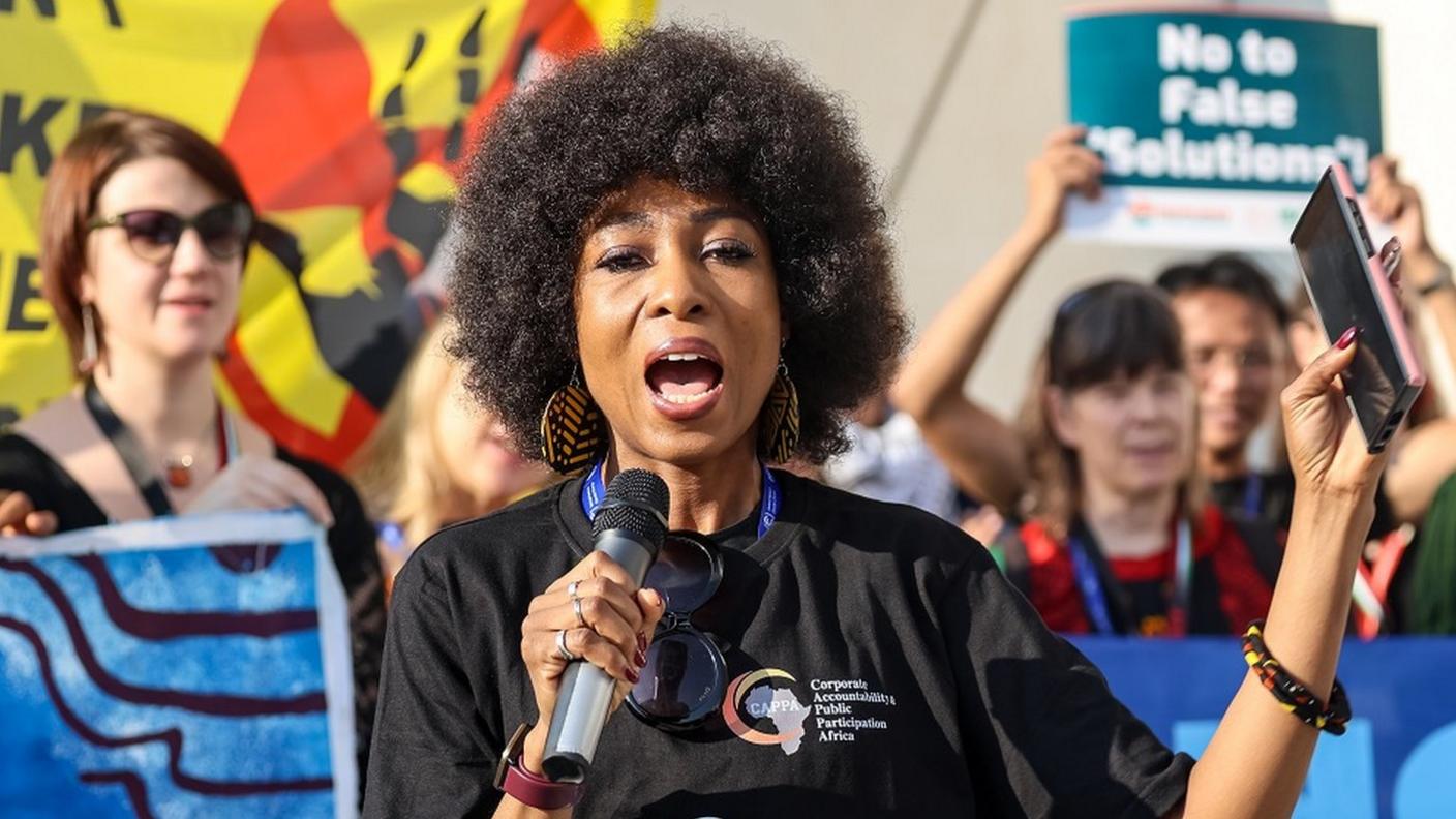 A protester at COP speaks into a microphone