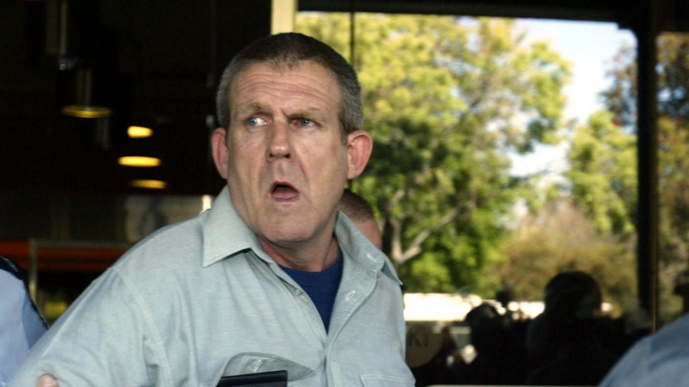 Bradley Murdoch is seen in police custody outside the Supreme Court of Adelaide, South Australia.
