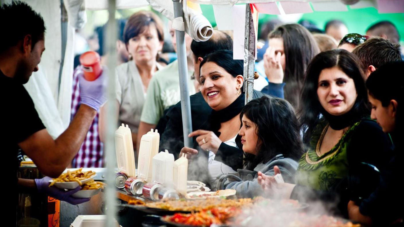 View from behind a food stall, looking out at customers