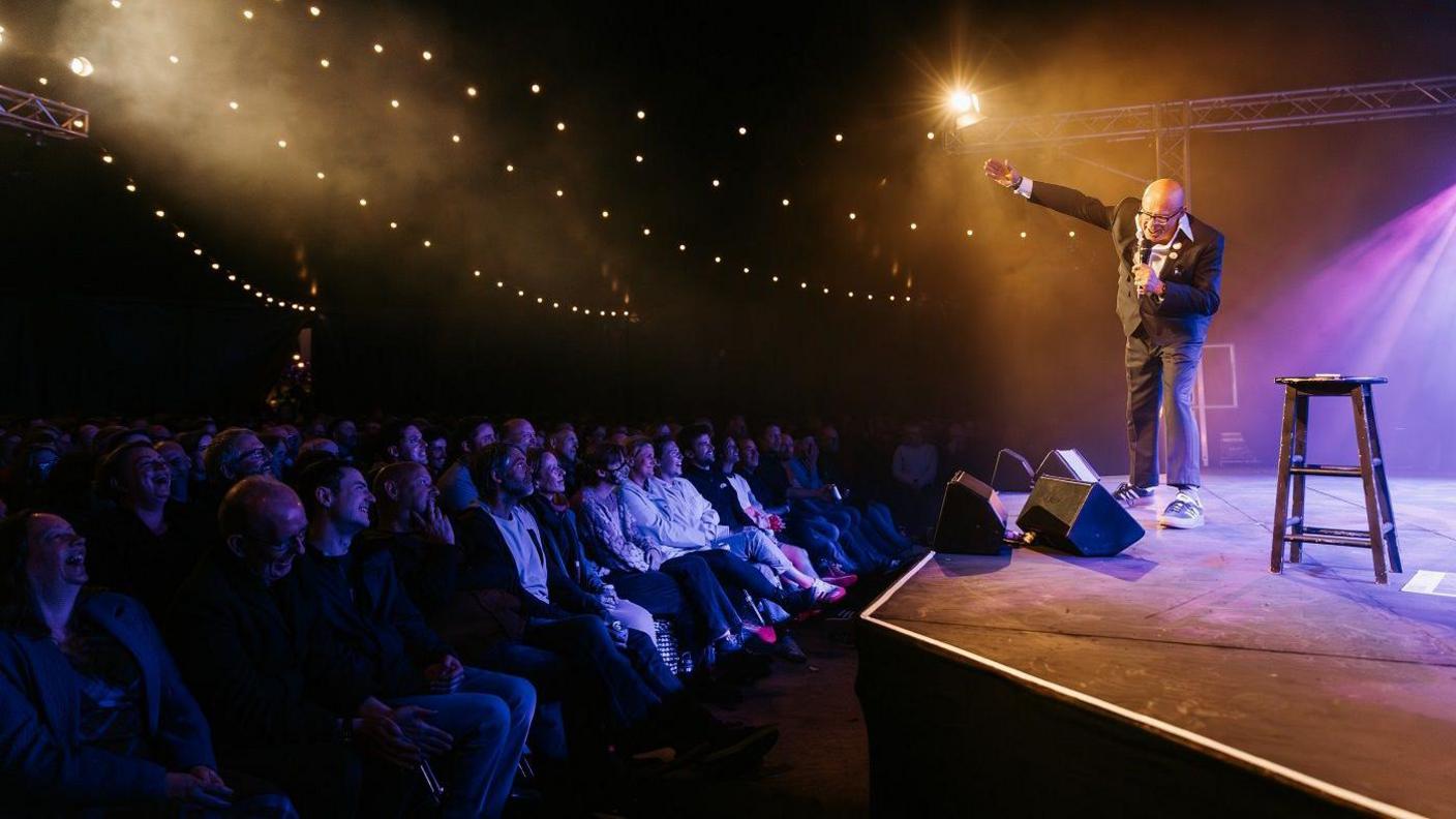 Harry Hill on stage at Bristol Comedy Garden in Queen Square