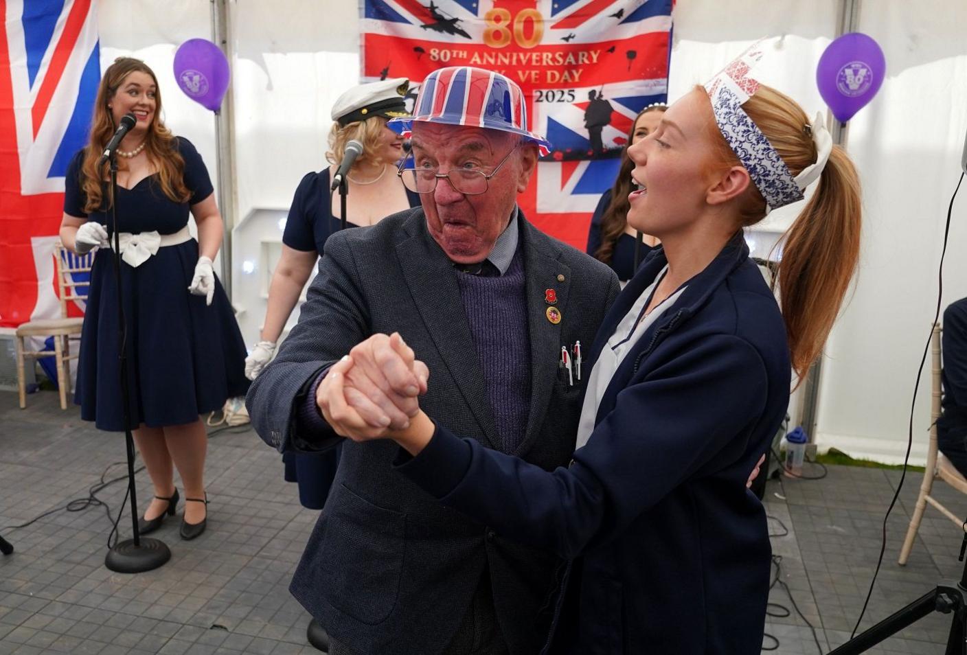 Veteran dancing with care home worker.