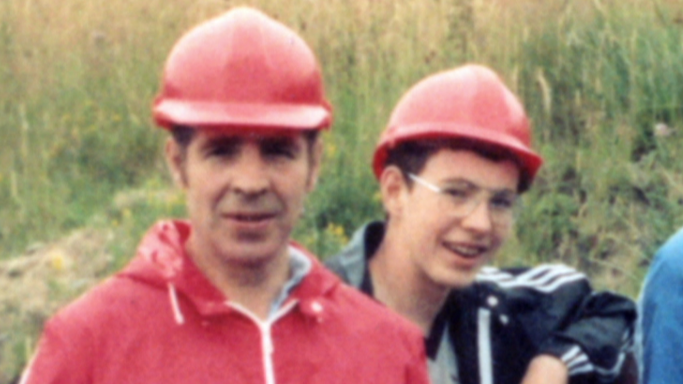 Young Adam with his dad Rufus Price, wearing red hard hats