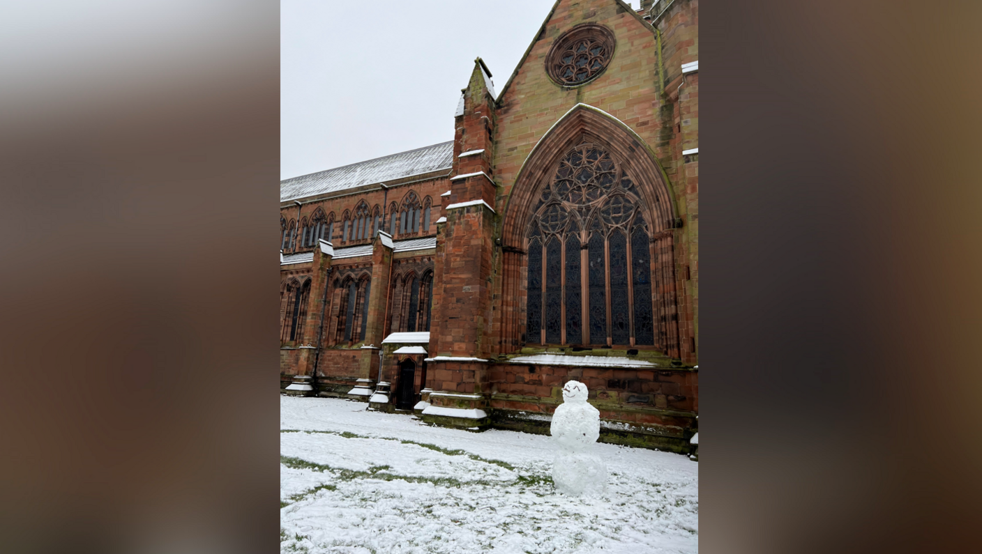 Snowman in front of The Abbey in Carlisle