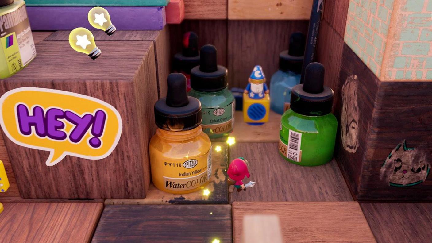 A tiny pink hero character is dwarfed by glass bottles labelled as watercolours with pipettes sticking out of the top. He's advancing towards a small plastic yellow speaker with a model of a cartoon wizard clad in blue robes on top of it.