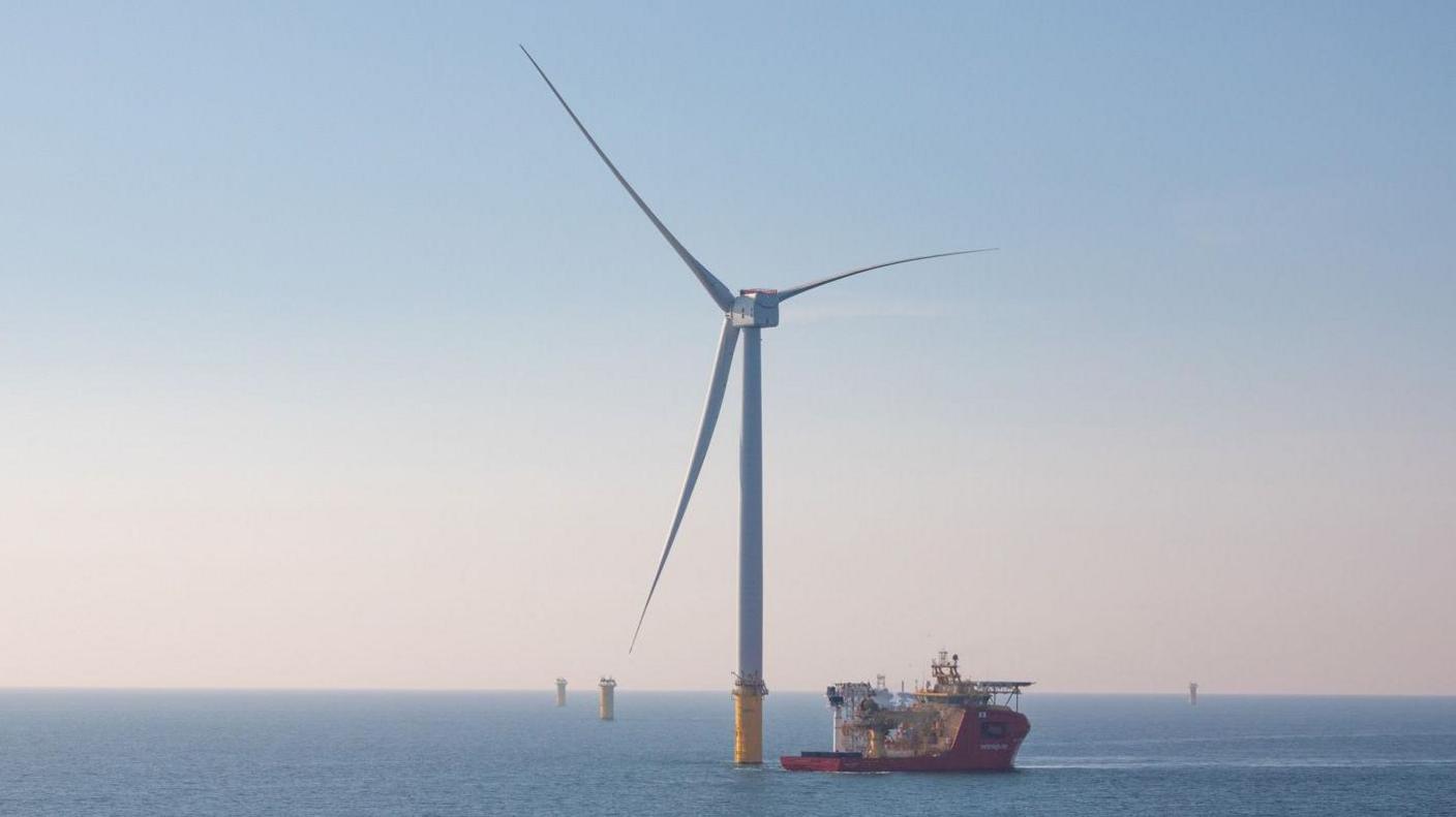 A North Sea supply vessel alongside one of the 260-metre high turbines