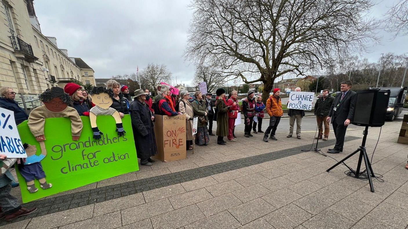 protesters holding placards outside the council house