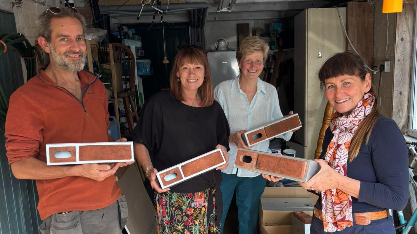 Volunteers from the Sheffield Swift Network charity holding the bricks.