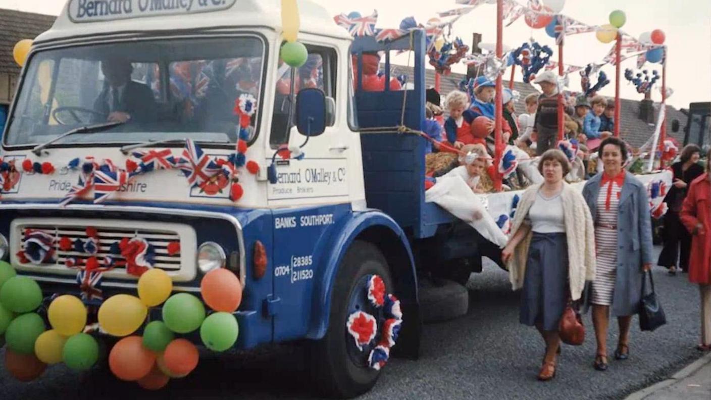 Bernard O'Malley and Co lorry decorated with Union Jack flags with children on the float in a Jubilee procession 