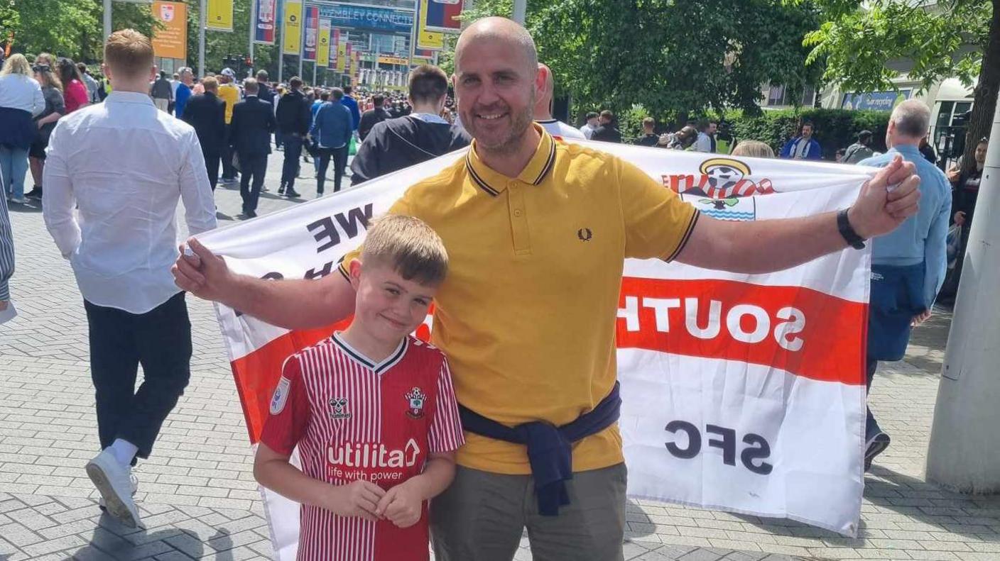 father and son stand outside Wembley stadium