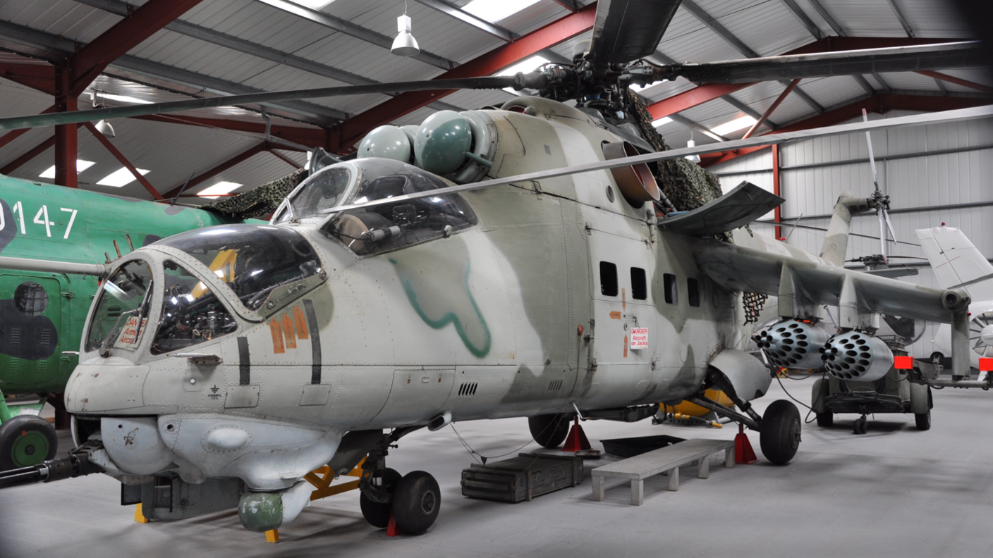 A close-up of one of the exhibits with military camouflage in the museum hangar