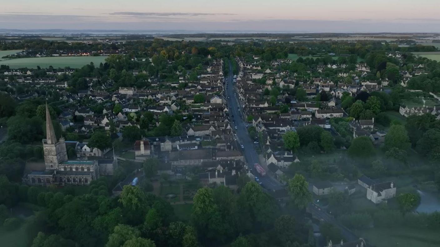 A drone image of Burford on a cloudy morning. Mist could be seen over the town.