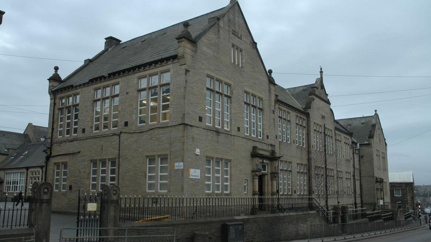 Heckmondwike Grammar School, a large building with Victorian frontage and railings