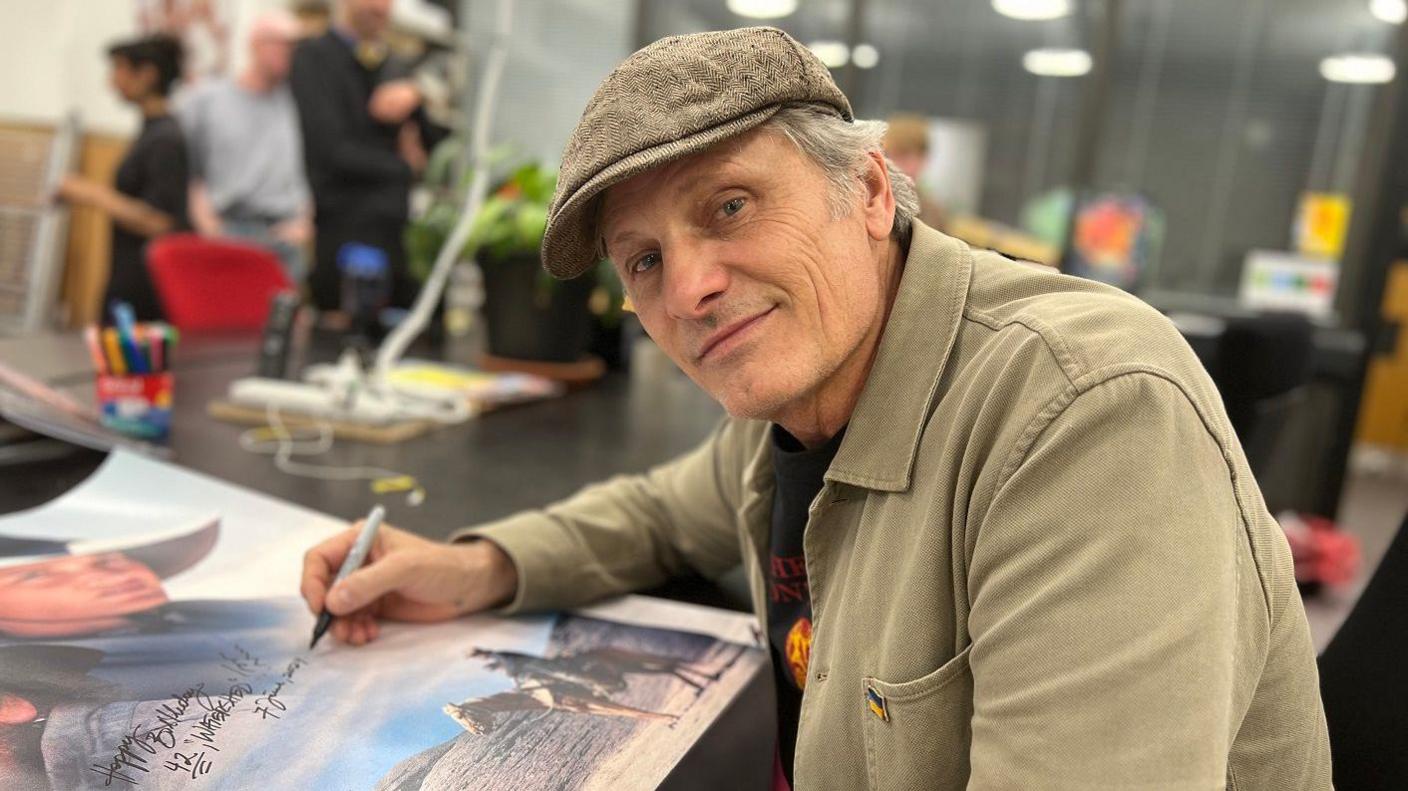 Actor Viggo Mortensen signs a poster at the Watershed Cinema in Bristol