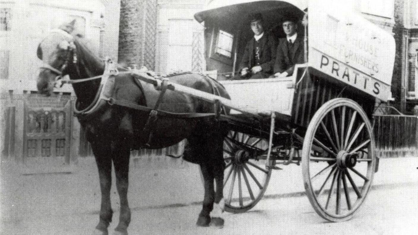 Horse and wagon with the name Pratts on the side