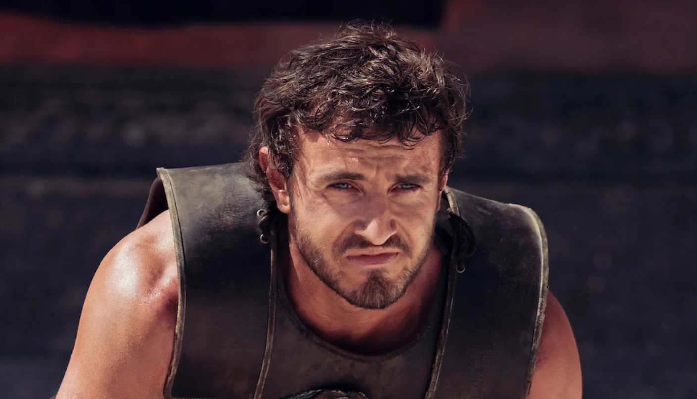 Paul Mescal, in the Gladiator costume. He has dark hair, and a beard.