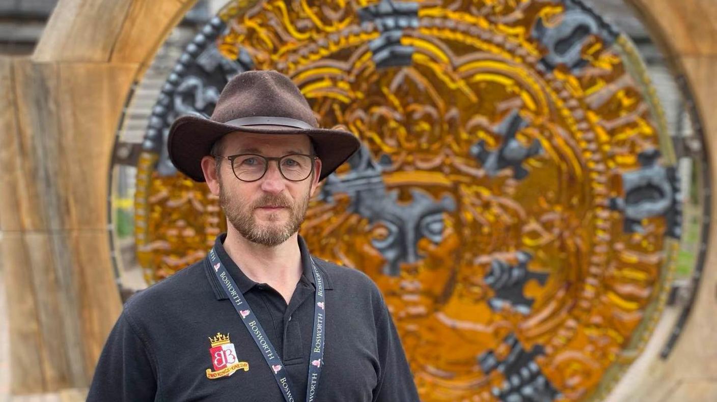 A man in a hat and Bosworth Battlefield logo shirt