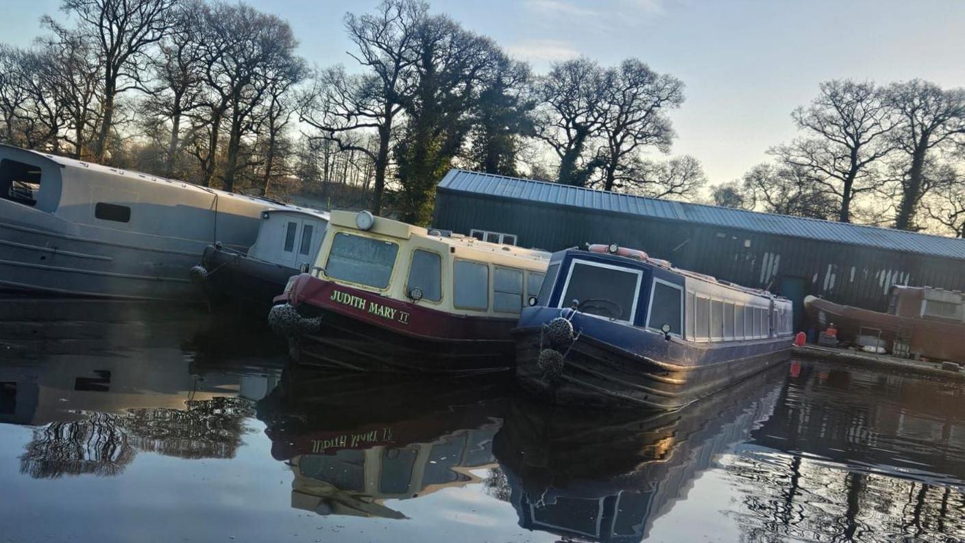 The two narrowboats moored next to each other on the Staffordshire and Worcestershire Canal