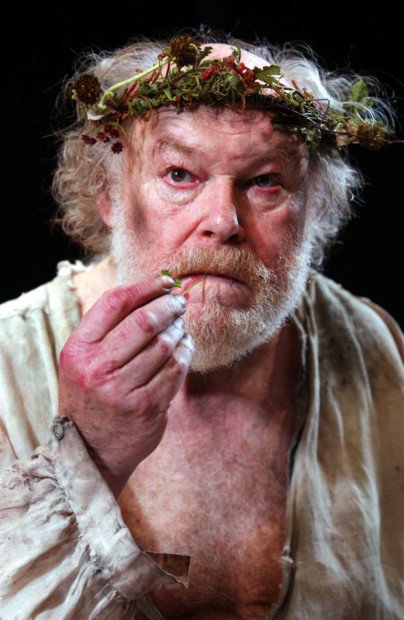 Timothy West in costume as King Lear with a crown of leaves and flowers