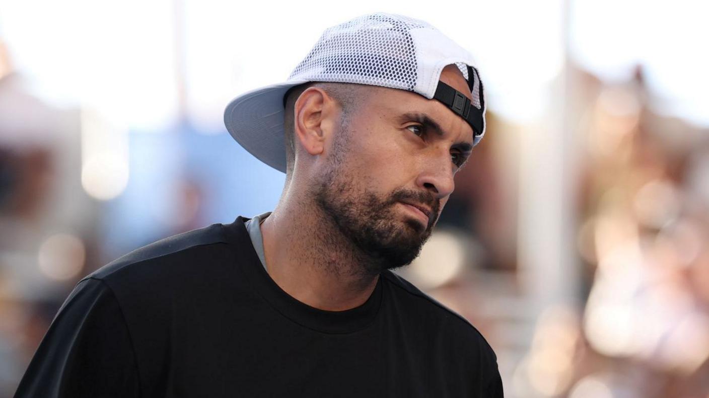 Nick Kyrgios reacts to a point while playing doubles at the Australian Open